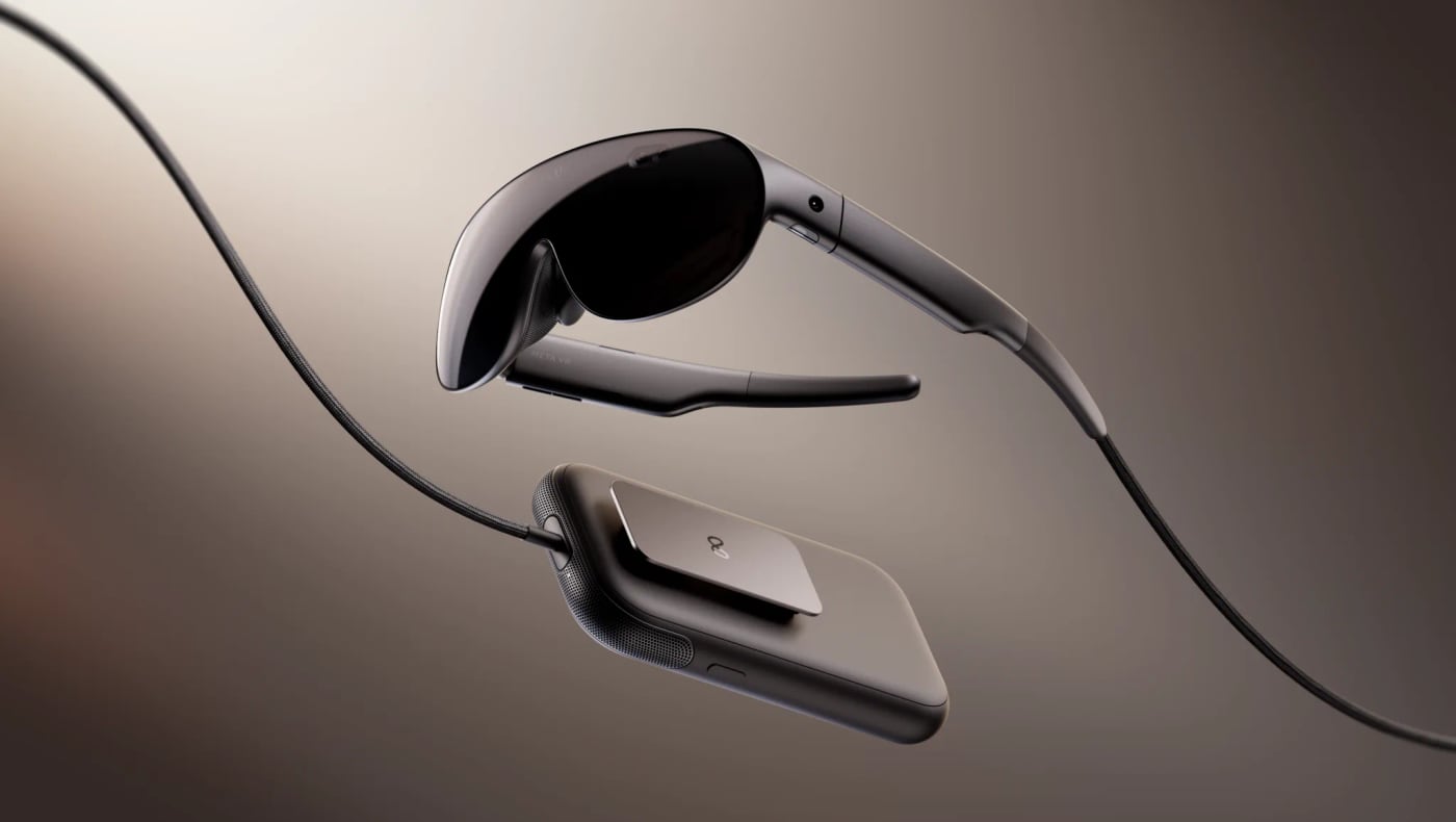 Meta VR Glasses, a slim pair of dark visor-style goggles, float above the flat compute puck they connect to by a cable